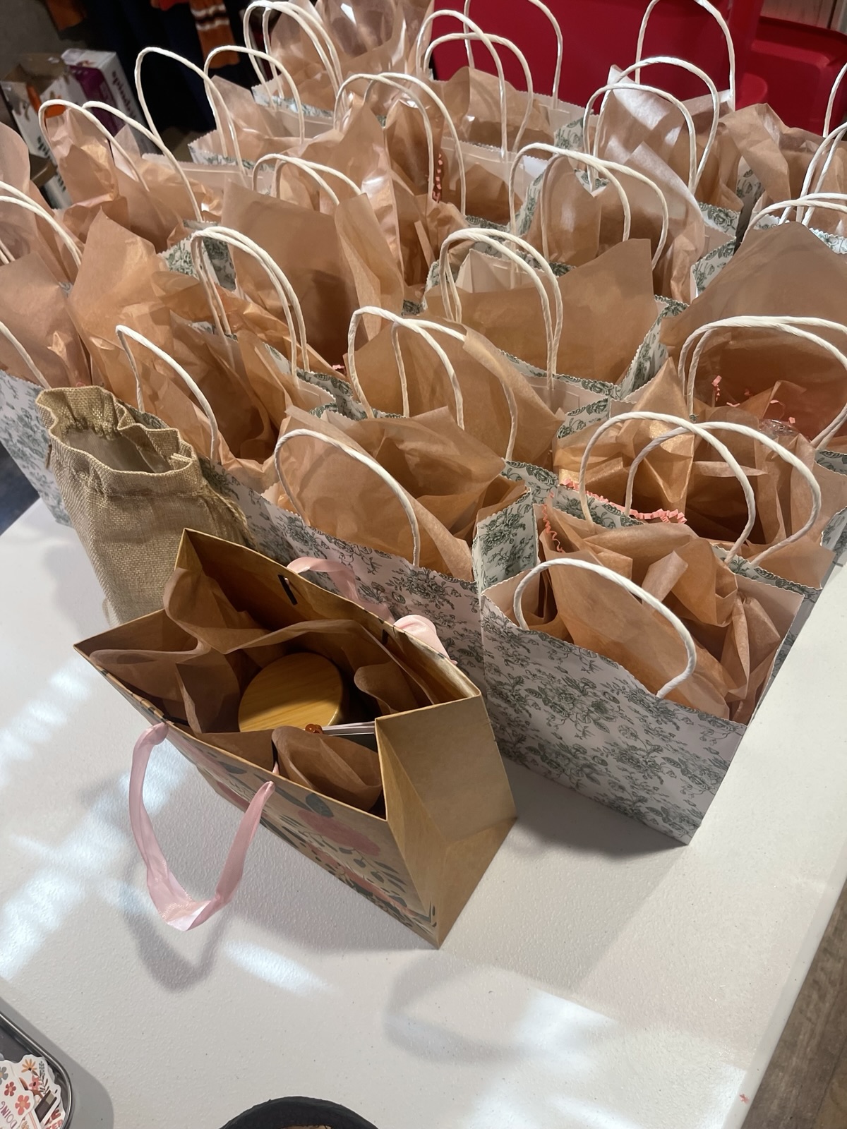 Kraft and floral gift bags lined up on a table