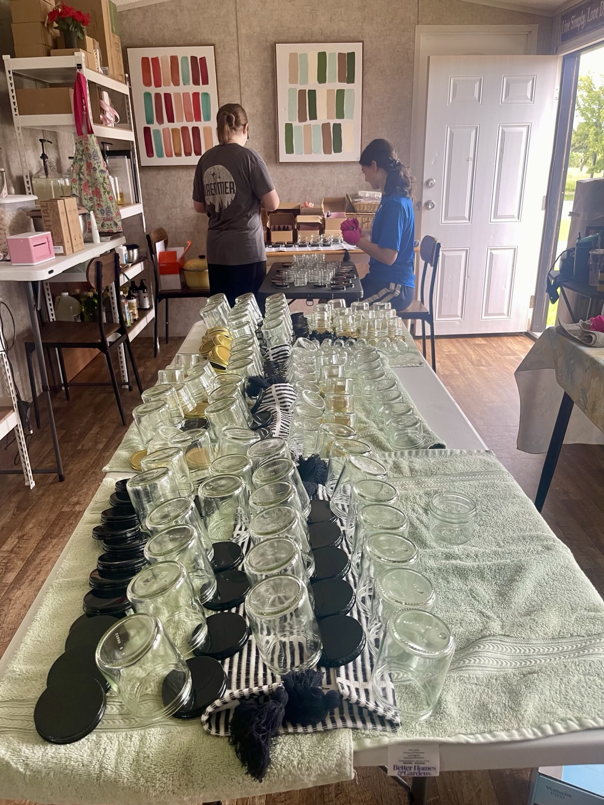 Rows of jars laid out on tables in the Angelic & Co. Studio, set up for a Radiant Bloom Workshop